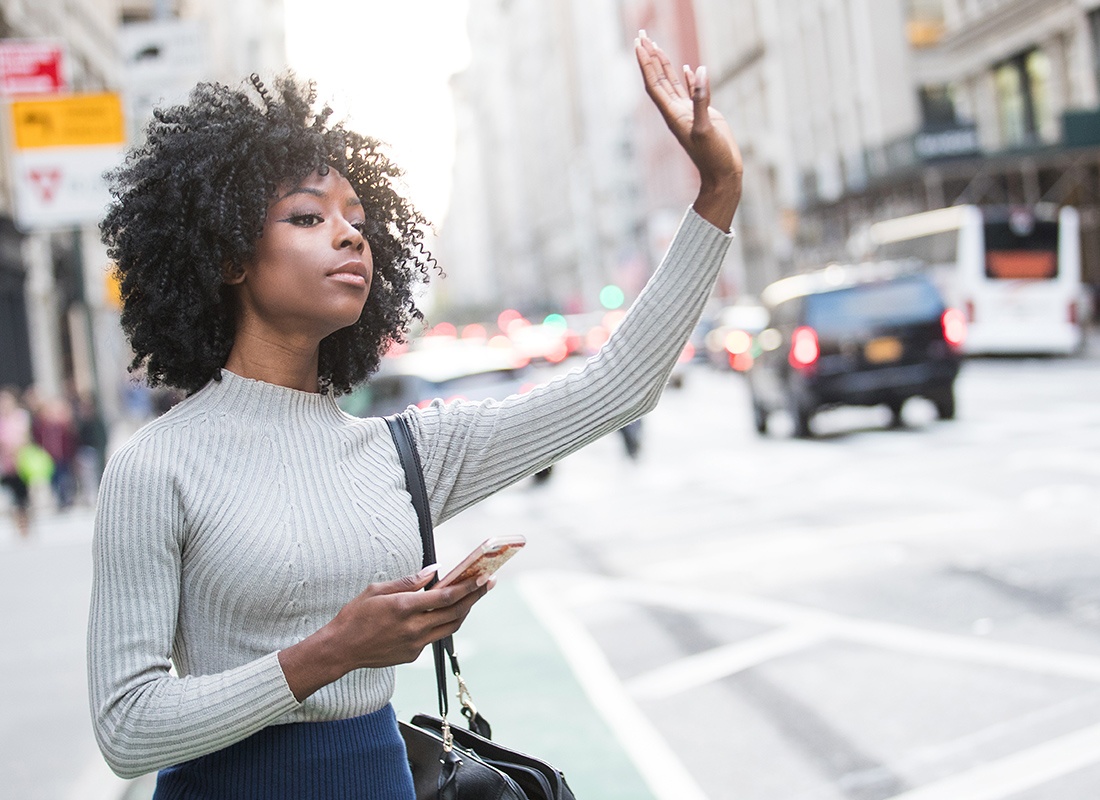 Personal Insurance - Woman Hailing a Taxi in New York